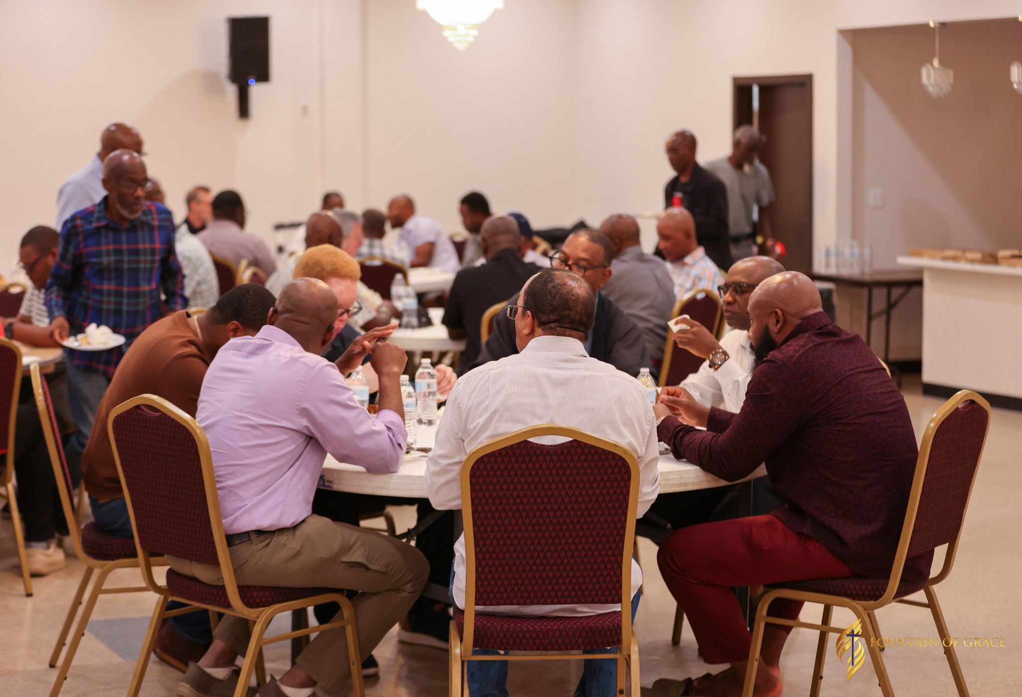 Men gathering together over coffee discussing
