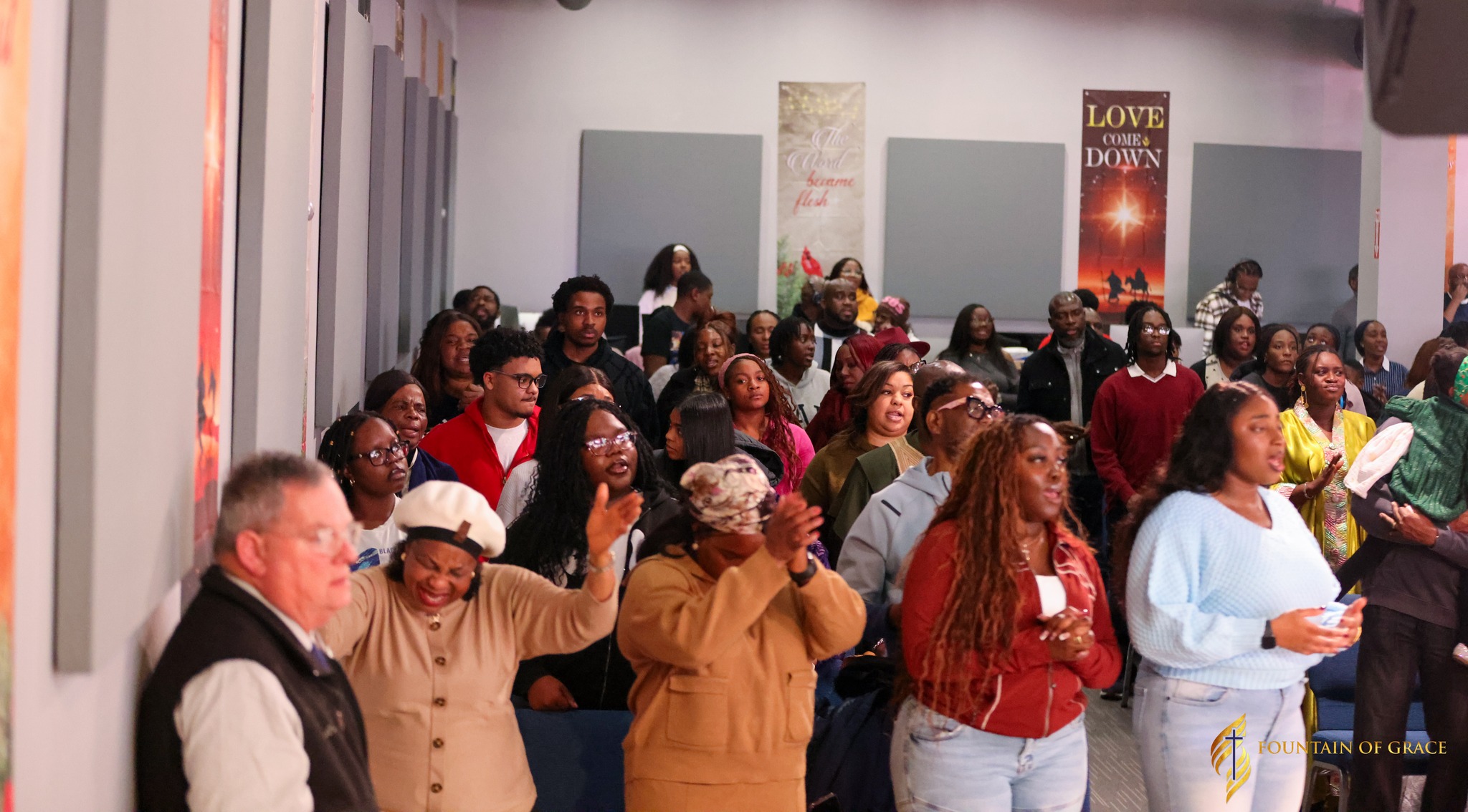 Women lifting hands up in deep emotional church prayer